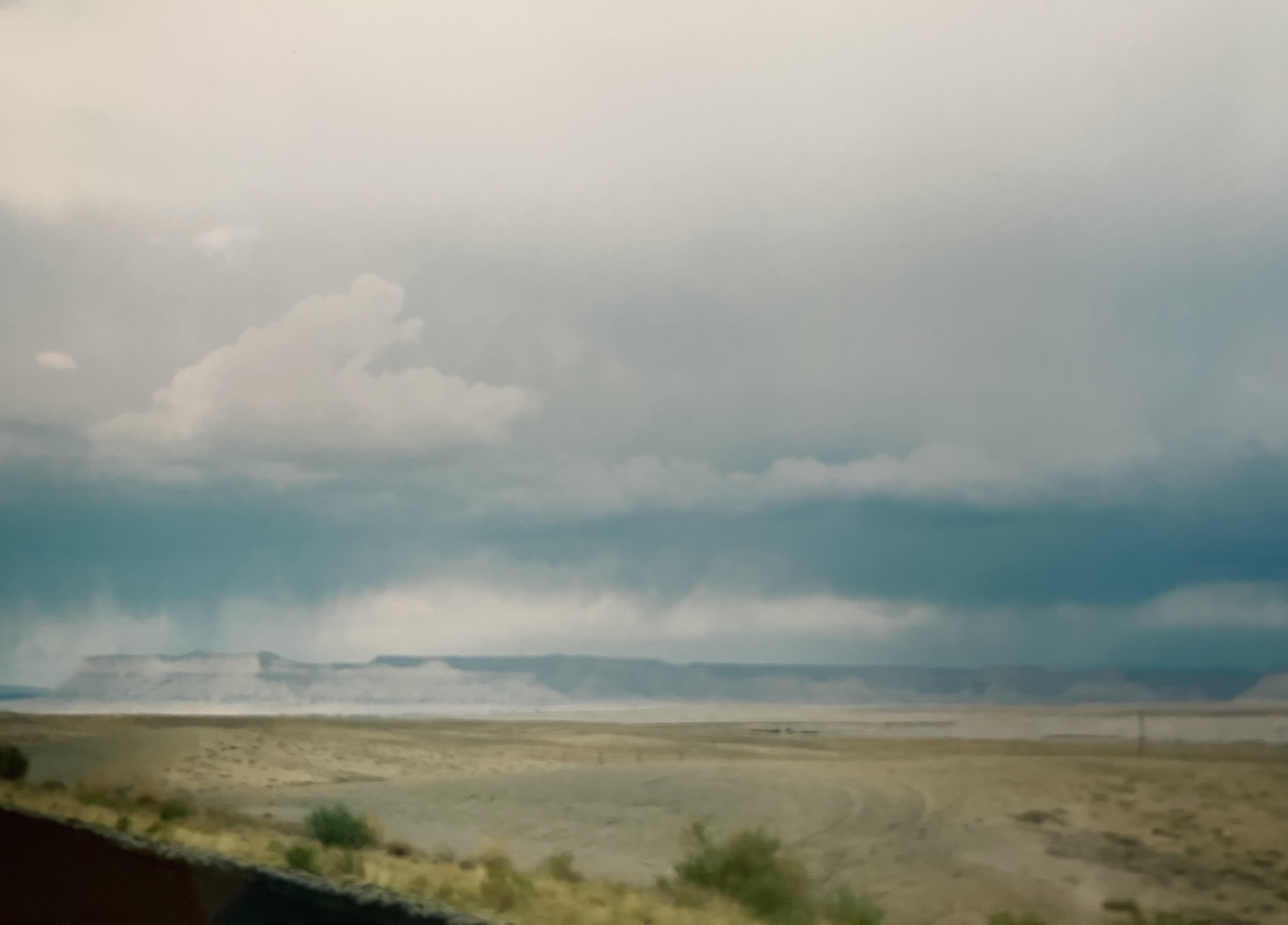 The badlands: isolated storms going off over the flat-topped mesas